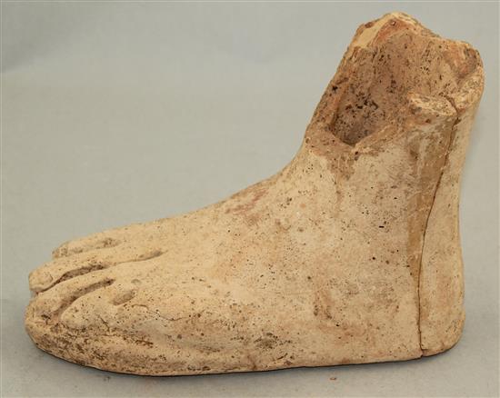 An Etruscan terracotta votive left foot, c.3rd century BC, 21cm, repaired